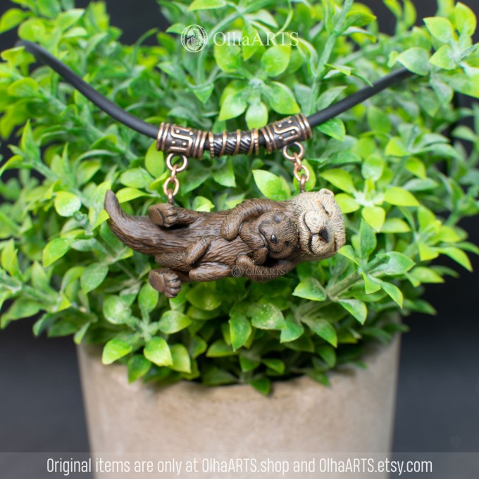 Necklace with two otters. Mother and baby otters.