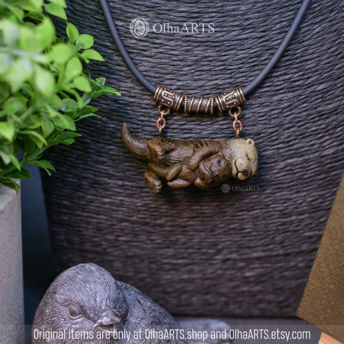 Necklace with two otters. Mother and baby otters.