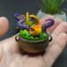 Mini figurine with a little dragon in a witch's cauldron