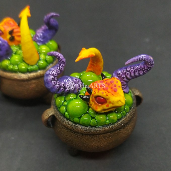 Mini figurine with a little dragon in a witch's cauldron