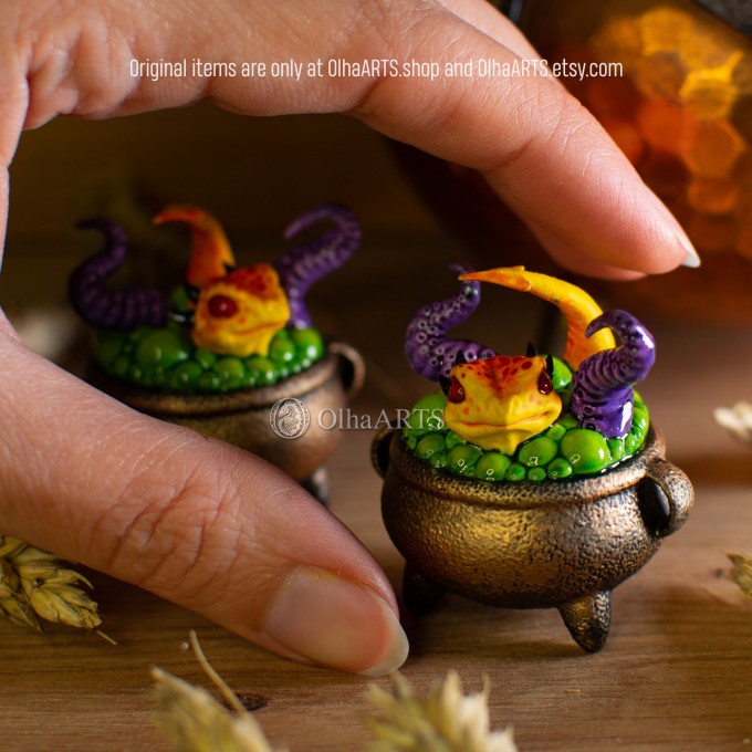 Mini figurine with a little dragon in a witch's cauldron