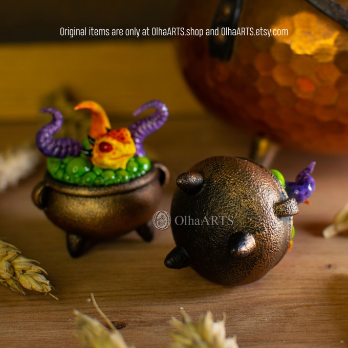 Mini figurine with a little dragon in a witch's cauldron