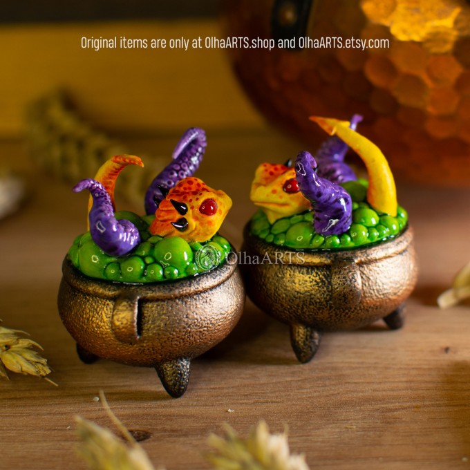 Mini figurine with a little dragon in a witch's cauldron